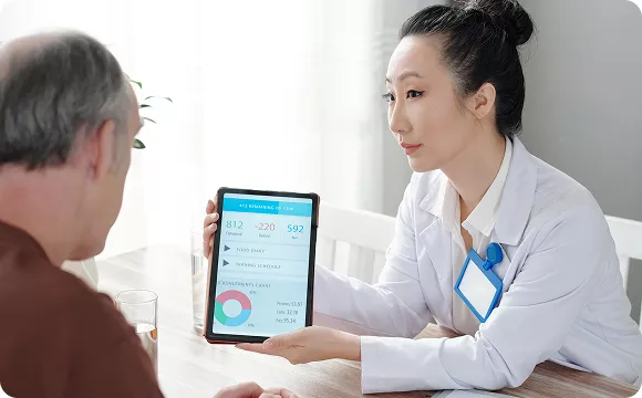 A doctor explaining results to a patient on a tablet